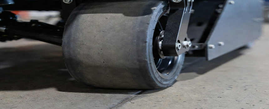 AMR solid wheel maintaining uniform contact with a superflat concrete floor in an indoor warehouse.
